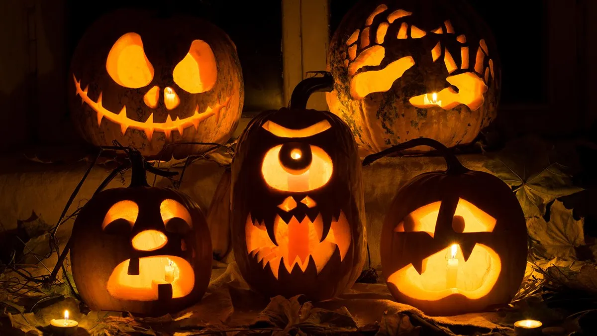 Carved pumpkins, lit from within with candles