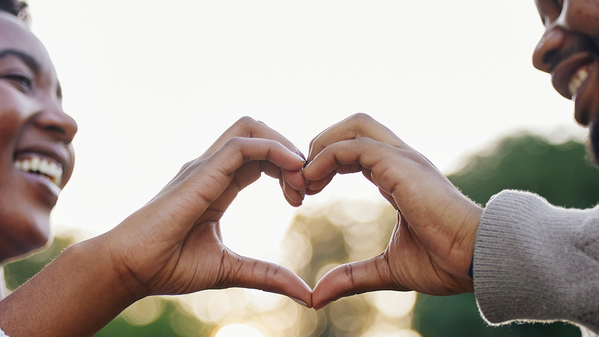 Couple making a heart with their hands