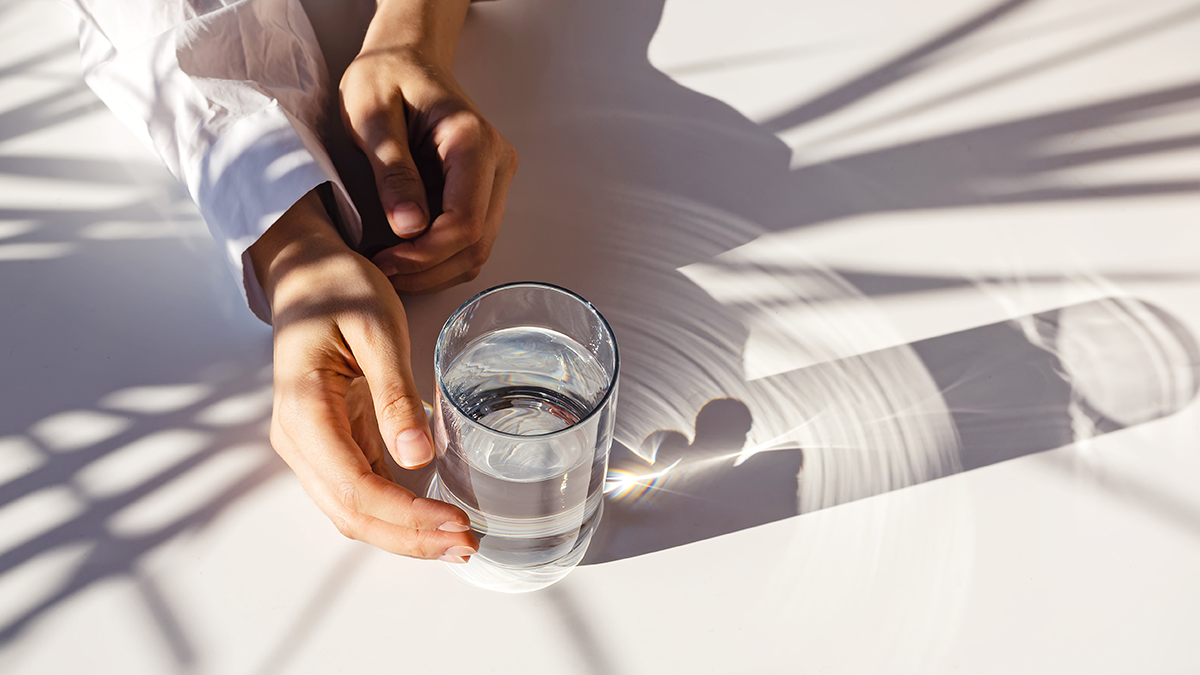 Light shining through glass of water