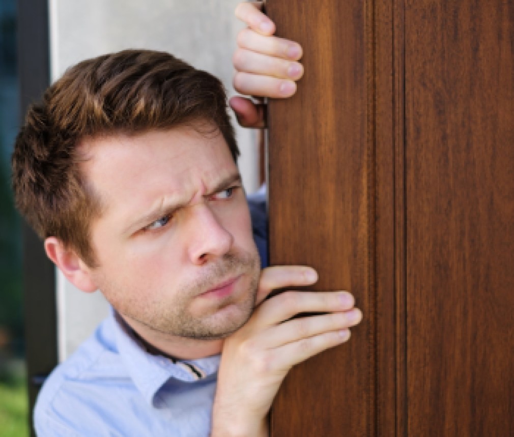 man looking out door