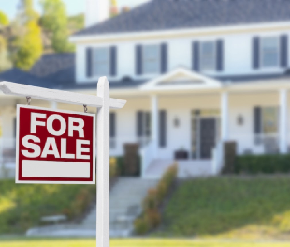 Home For Sale Real Estate Sign in Front of Beautiful New House.