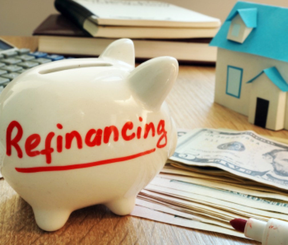 Refinancing written on a piggy bank.