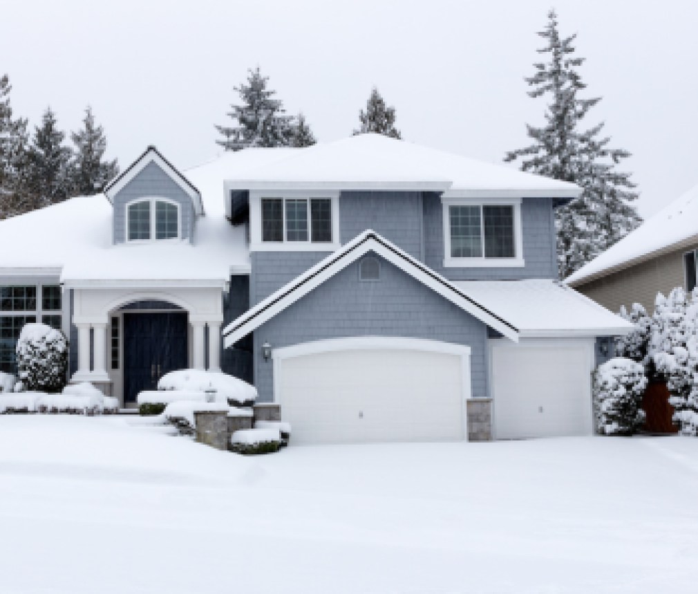 Snowing with residential Pacific Northwest home in background