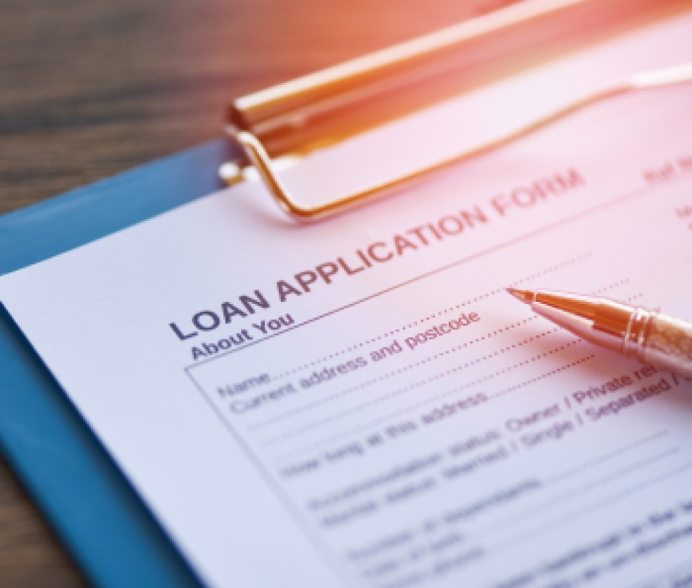 Loan application form with pen on paper / financial loan negotiation for lender and borrower