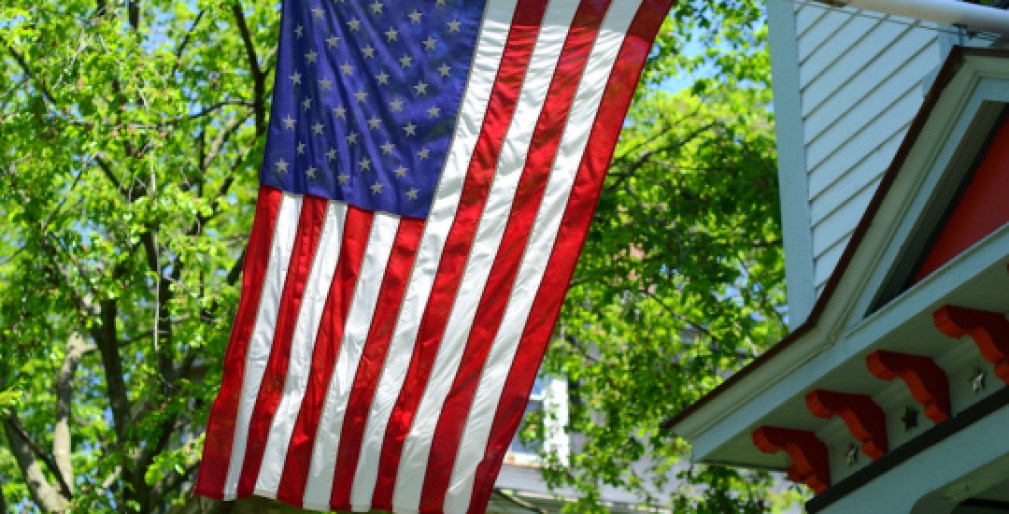 American Flag Outside A House In Small Town USA