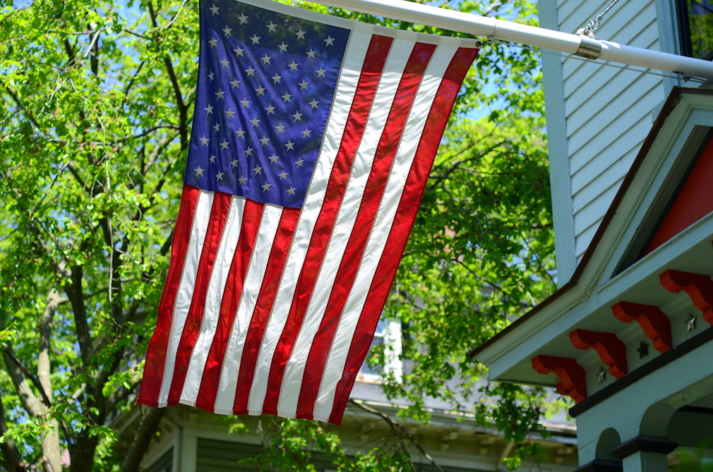 American Flag Outside A House In Small Town USA