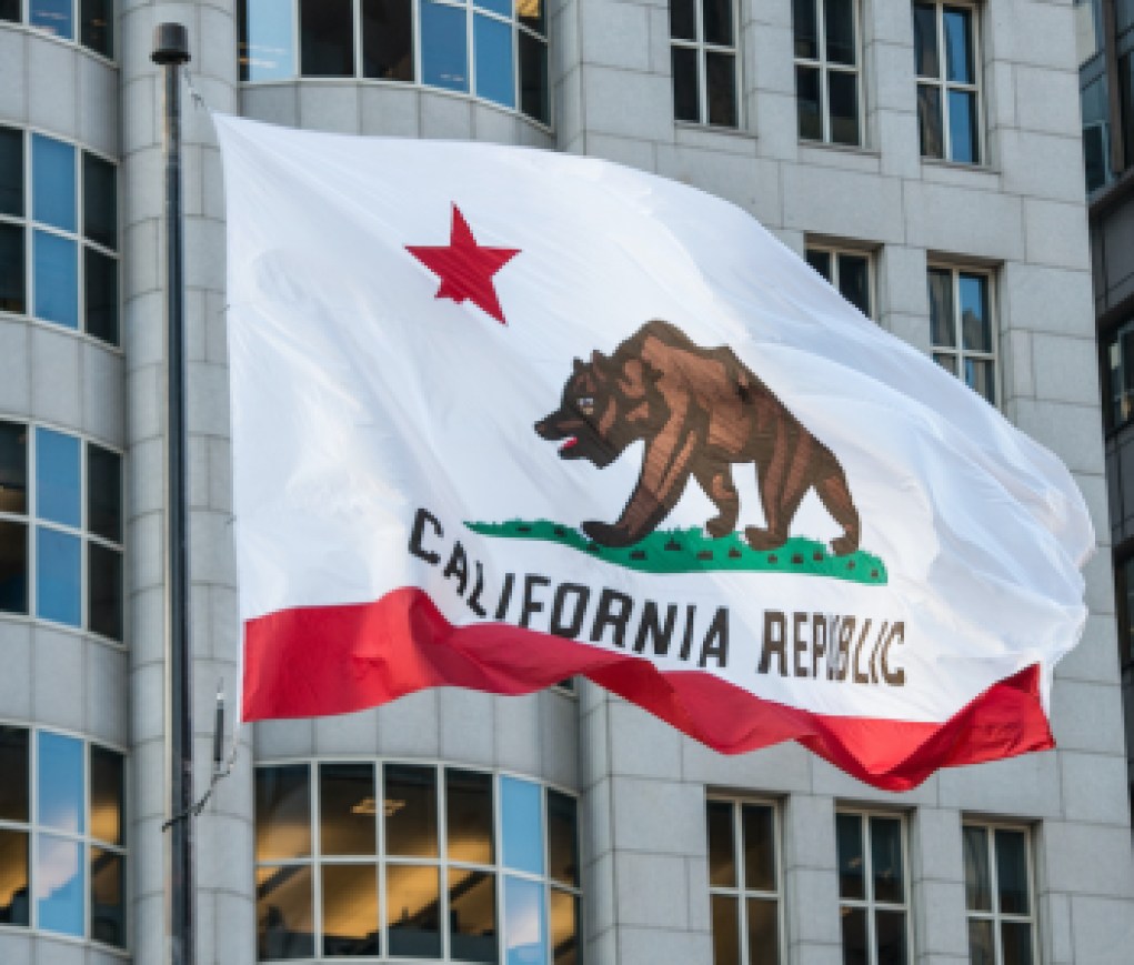 California Republic flag with grizzly bear raised in city downtown