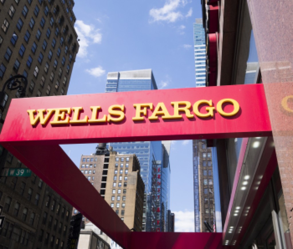 New York, New York, USA - May 31, 2012: A Wells Fargo sign at a Wells Fargo location in Midtown Manhattan. Manhattan buildings can be seen in the background.