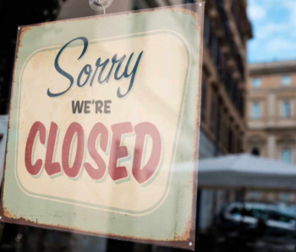 "Sorry we're closed" board on a window, abandoned closed and shut down shop, cafe restaurant or other business, coronavirus COVID-19 disease global pandemic outbreak, isolation and quarantine concept