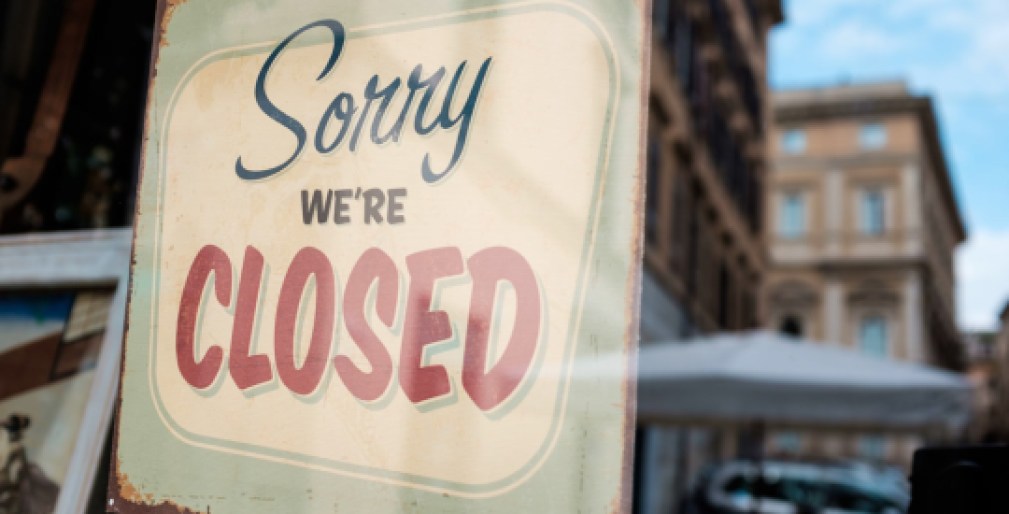 "Sorry we're closed" board on a window, abandoned closed and shut down shop, cafe restaurant or other business, coronavirus COVID-19 disease global pandemic outbreak, isolation and quarantine concept