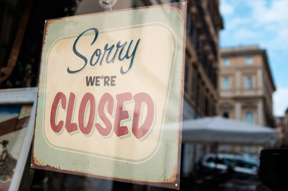 "Sorry we're closed" board on a window, abandoned closed and shut down shop, cafe restaurant or other business, coronavirus COVID-19 disease global pandemic outbreak, isolation and quarantine concept