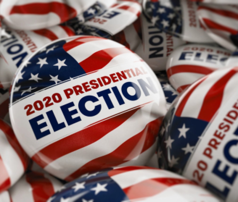 Closeup shot of one presidential election button in focus in between many other buttons in a box. Selective focus with shallow depth of field.