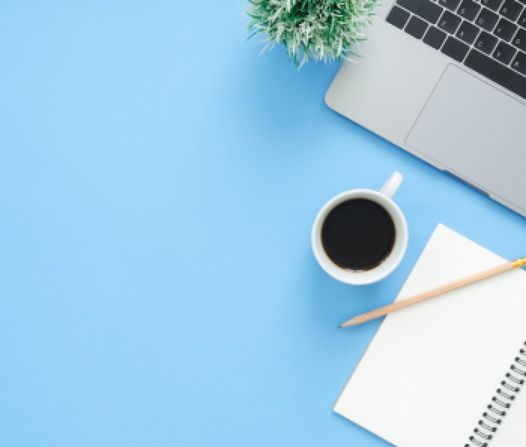 Minimal work space - Creative flat lay photo of workspace desk. Top view office desk with laptop, notebooks and coffee cup on blue color background. Top view with copy space, flat lay photography.