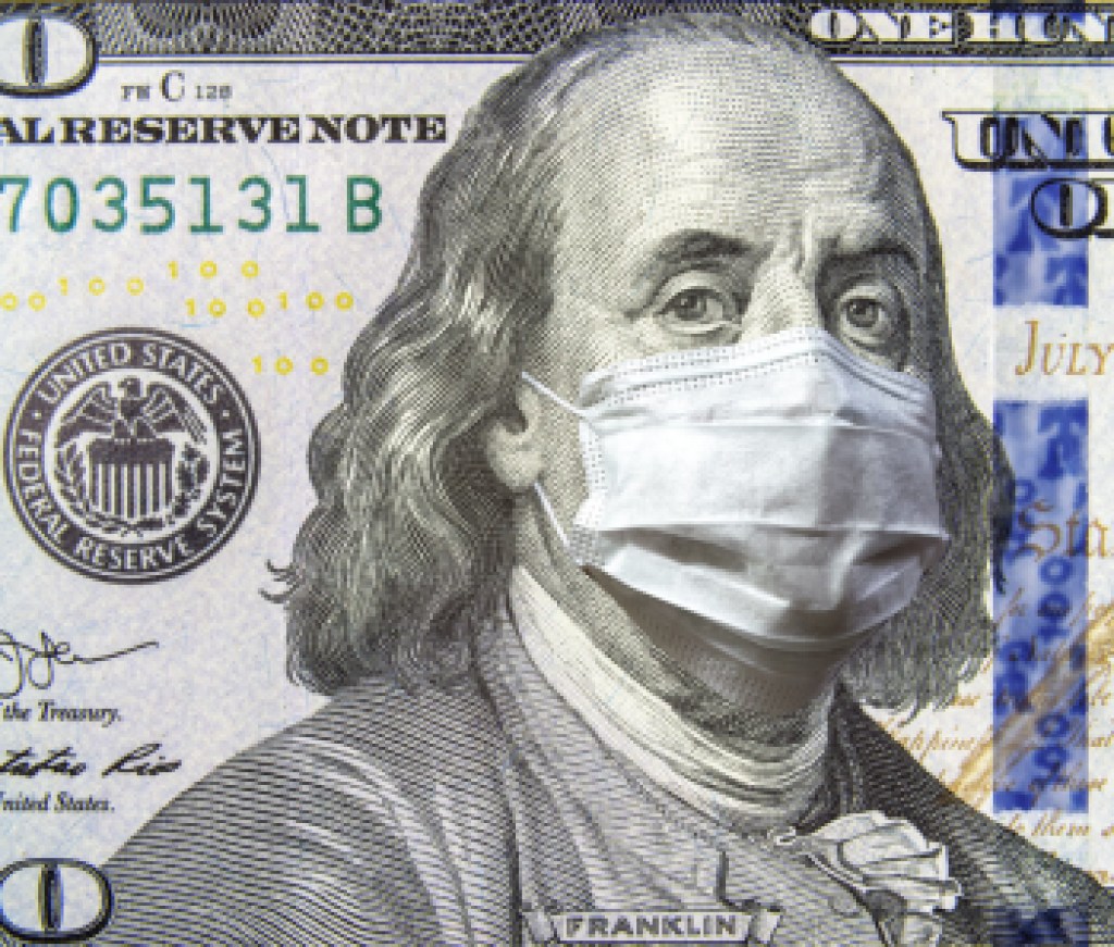 COVID-19 coronavirus in USA, 100 dollar money bill with face mask. Coronavirus affects global stock market.