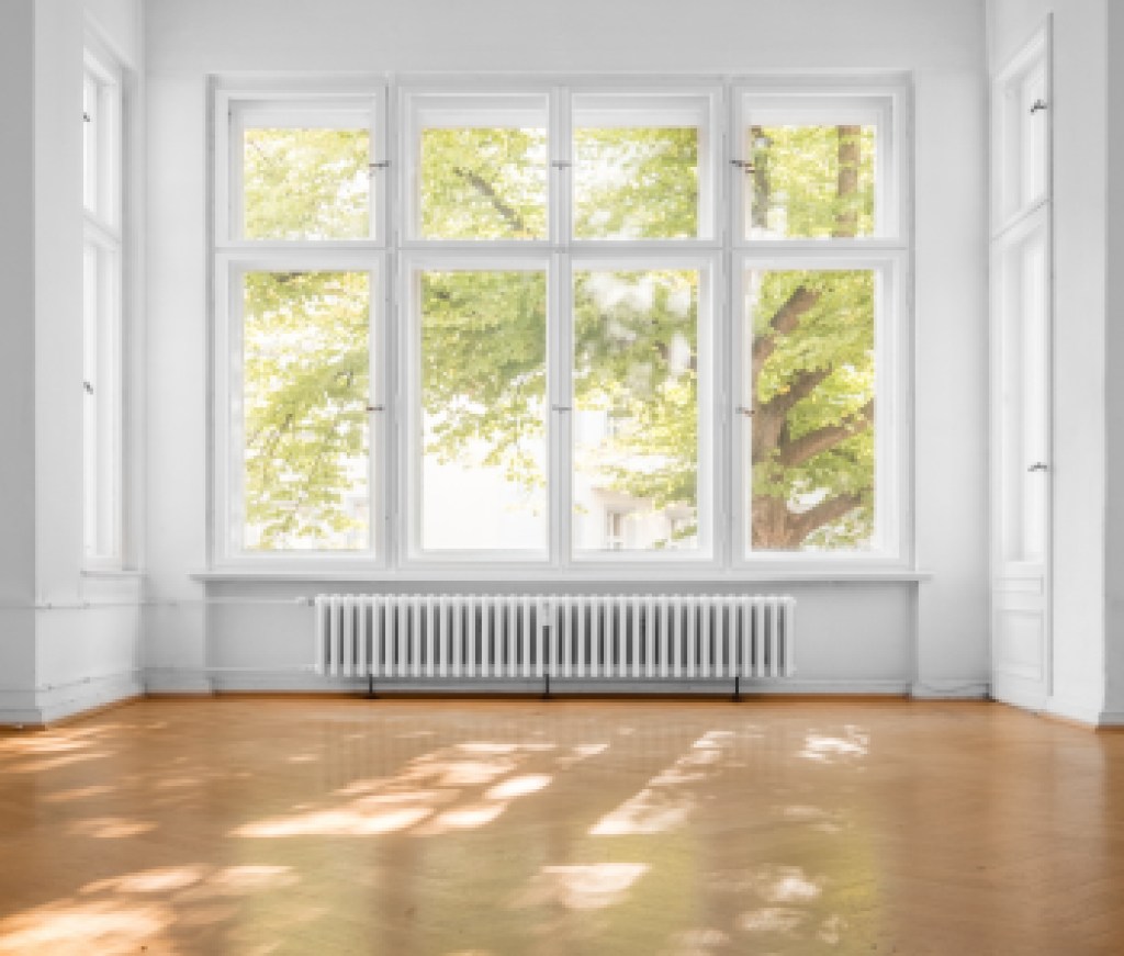 empty room in old apartment building with  parquet floor and big wooden windows