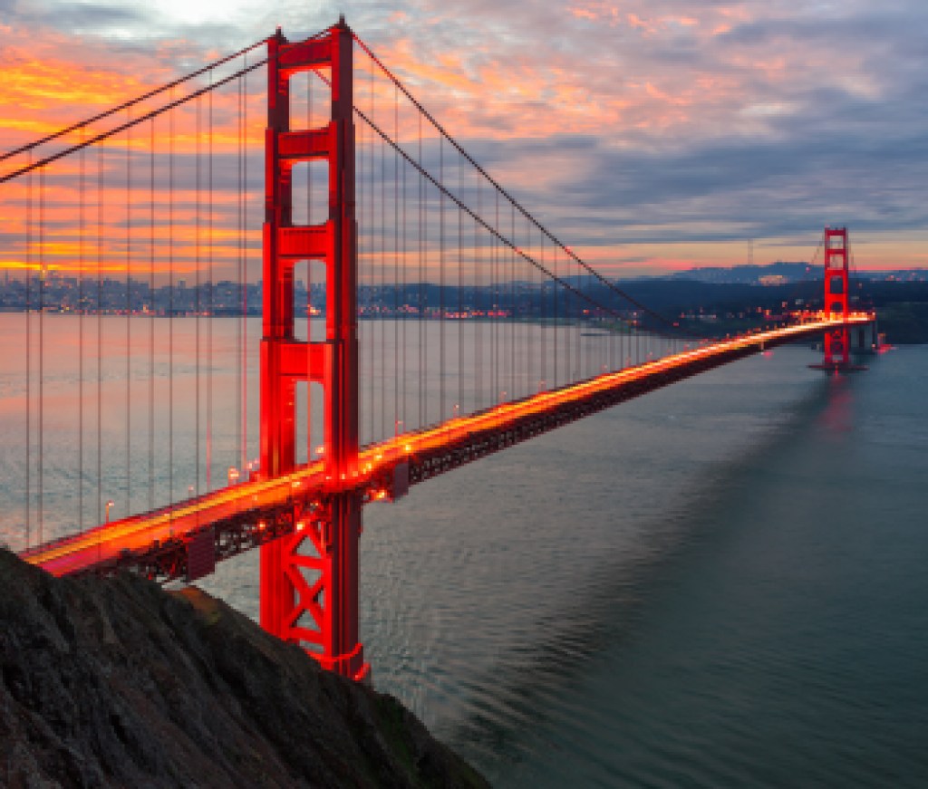 The sun rises over San Francisco and the Golden Gate Bridge