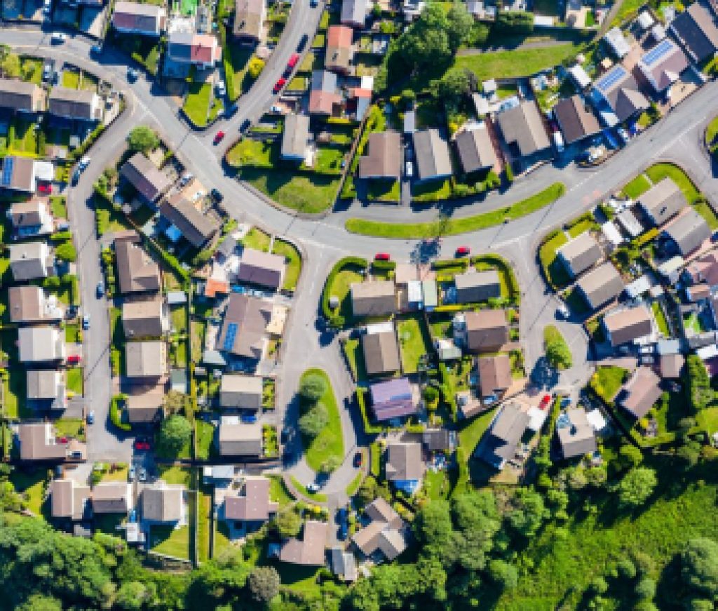 Aerial drone view of small winding sreets and roads in a residential area of a small town