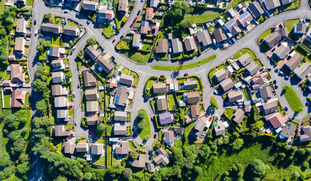 Aerial drone view of small winding sreets and roads in a residential area of a small town