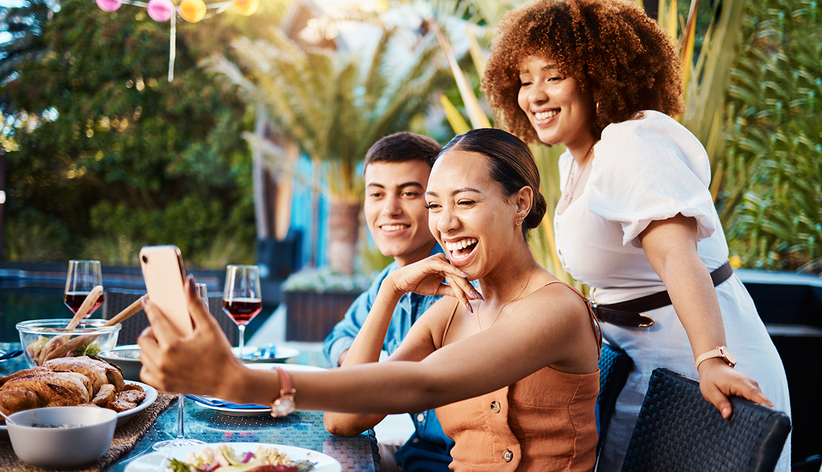 Group of young adults socializing and taking a selfie