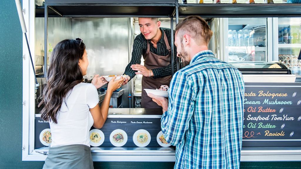 Young couple grabbing a bite to eat at a foot truck