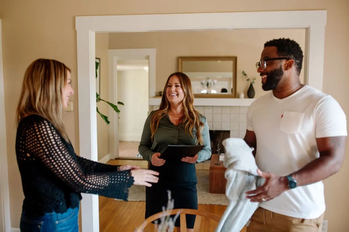 Happy couple with real estate agent