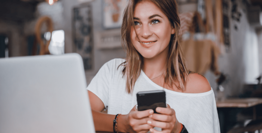 Woman sending email on mobile phone