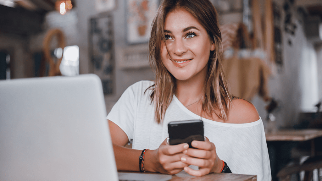 Woman sending email on mobile phone